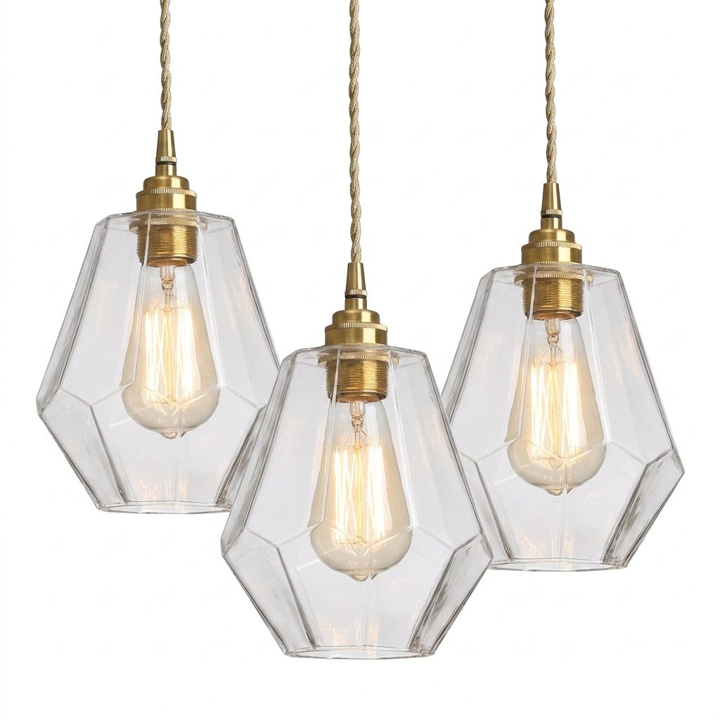 Faceted glass pendant lamp with brass fitting on a white background