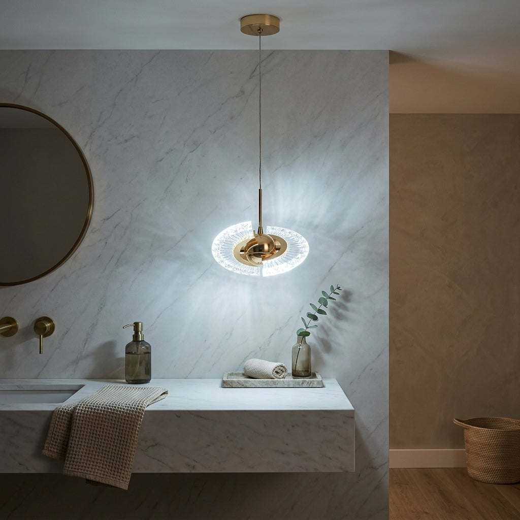 Gold crystal shell pendant light with cool white LED above a marble bathroom vanity