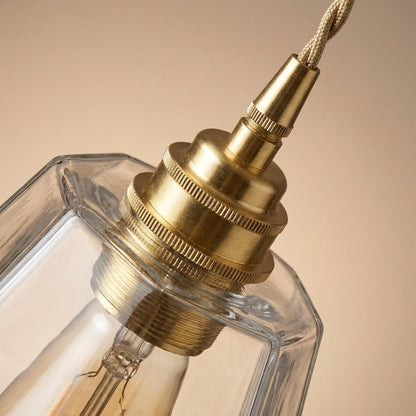 Close-up of the ribbed brass collar and faceted glass shade
