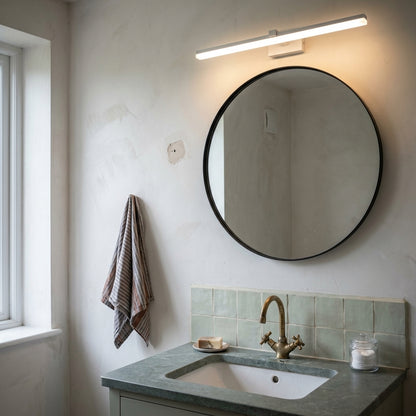 Slim LED Mirror Light 50 cm in matte white above a round mirror with soapstone washstand